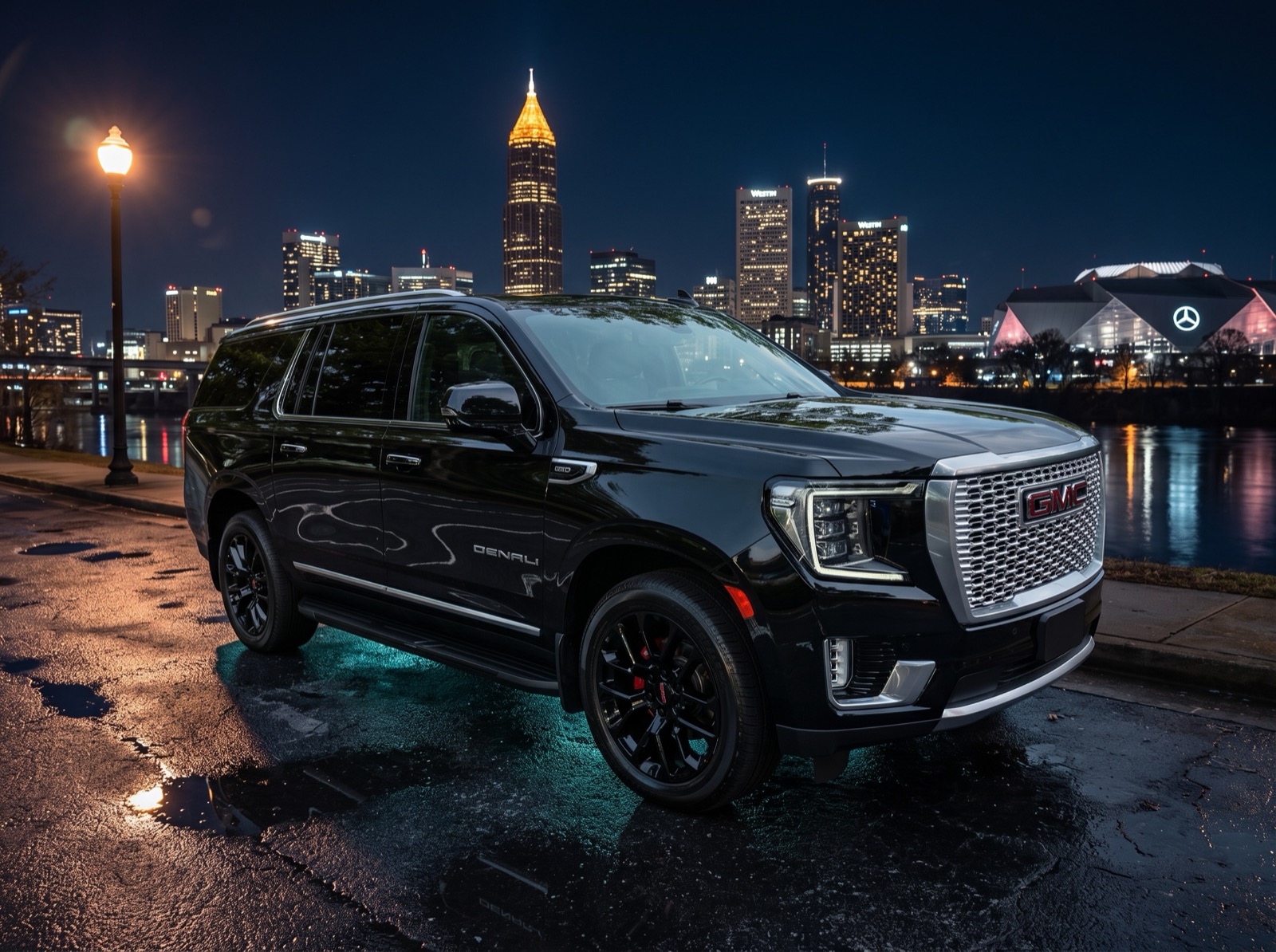 GMC Yukon Denali XL against the Atlanta skyline at night