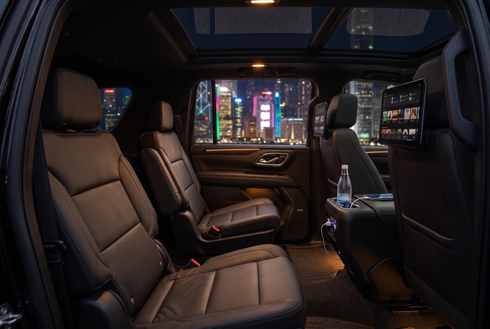 Rear cabin at night with bottled water and charging